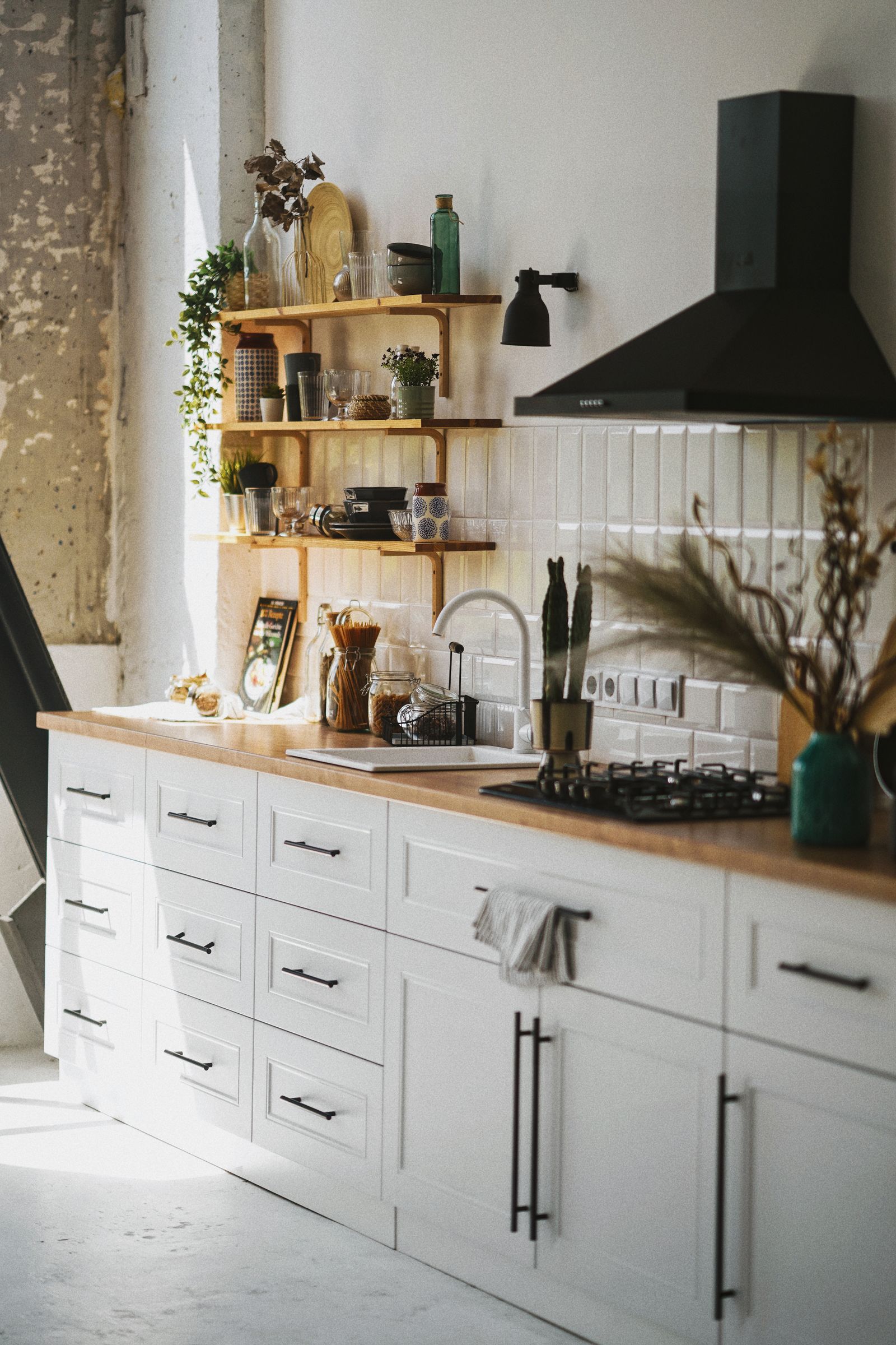 A compact electric kettle beside mugs in a lived-in morning kitchen