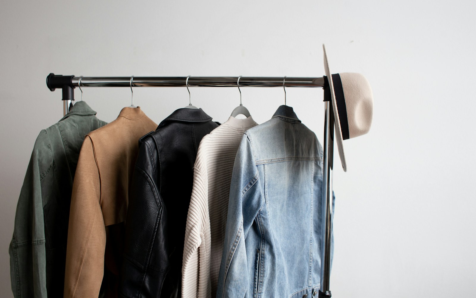 A woman styling a blazer in a relaxed modern apartment
