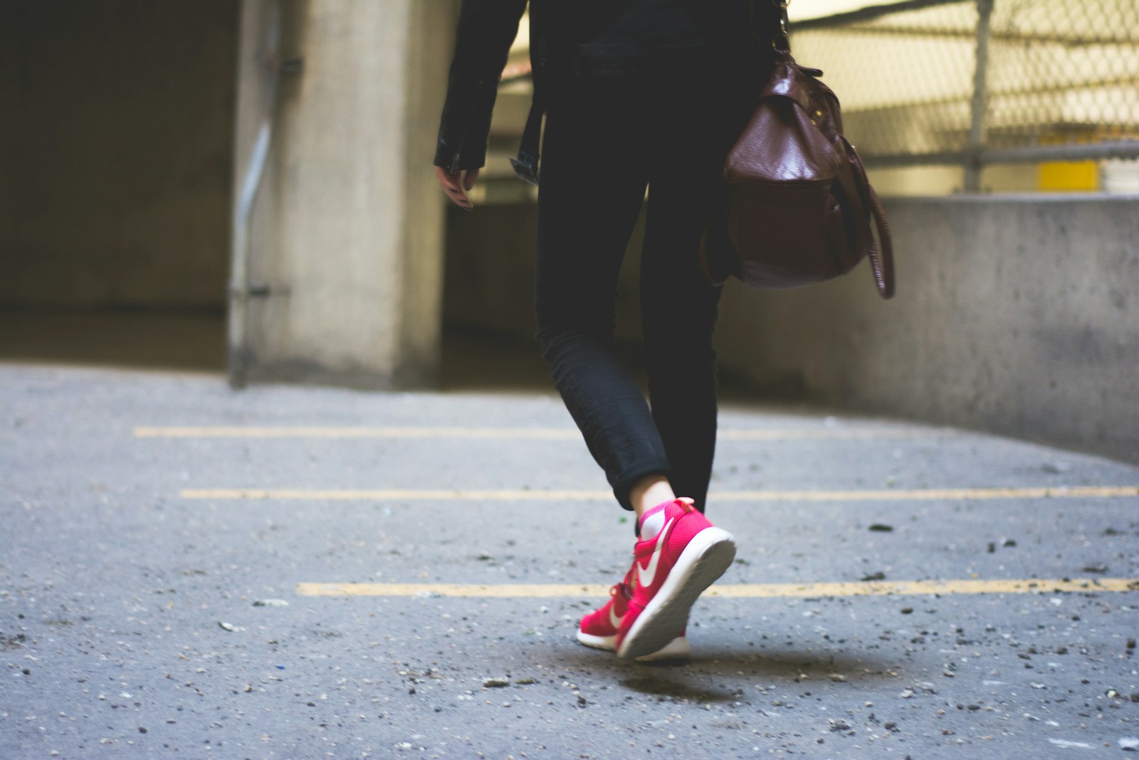 A woman lacing comfortable shoes before leaving a lived-in home