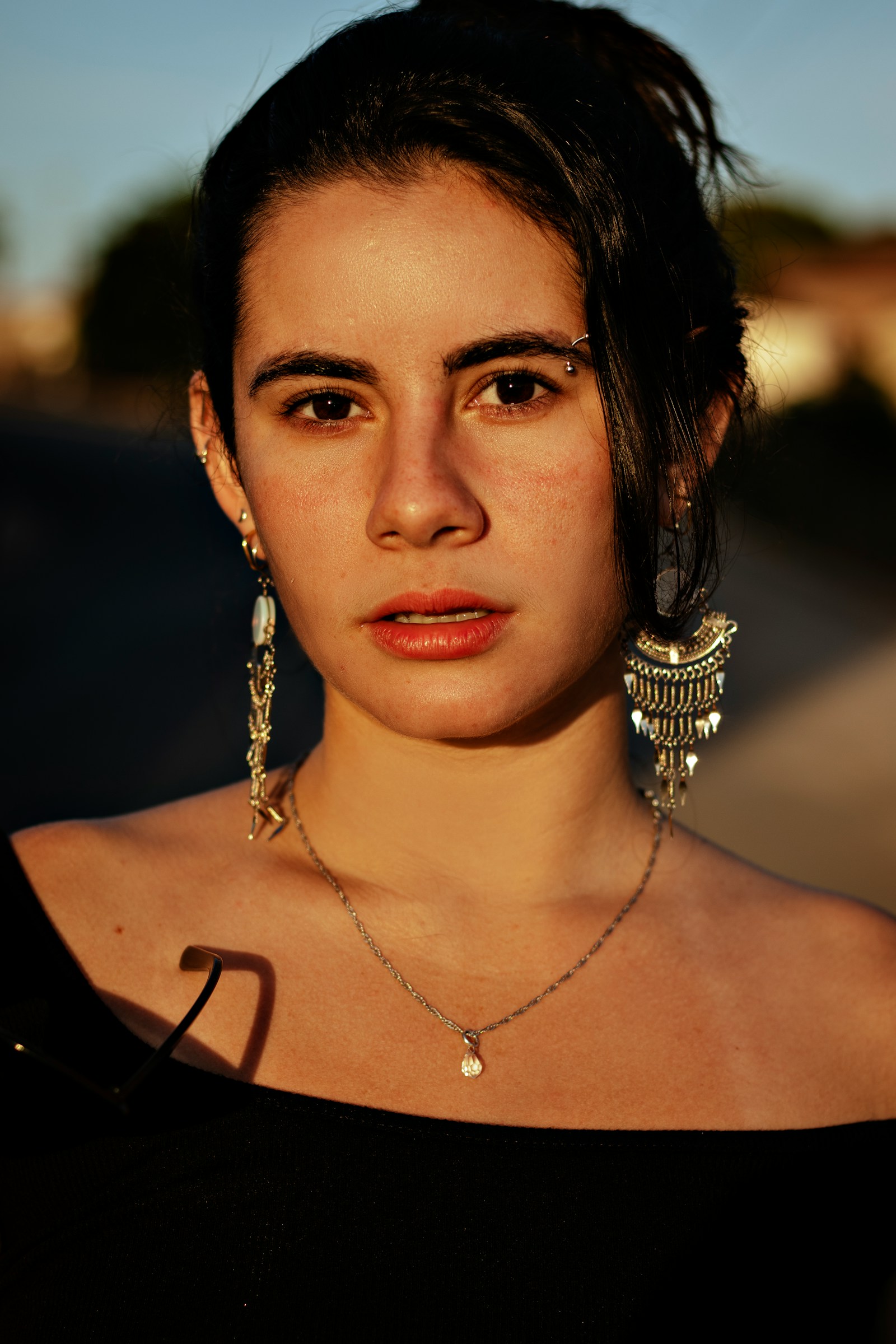 A close lifestyle portrait showing lightweight everyday earrings