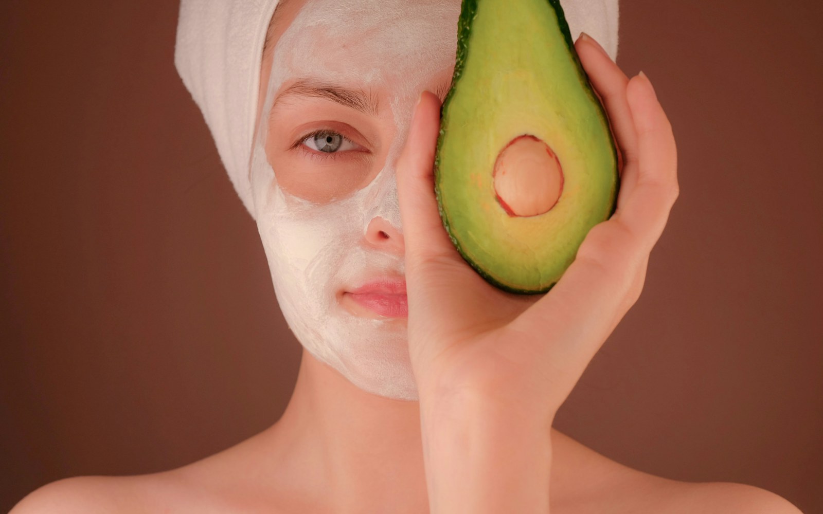 A person relaxing with a face mask in a realistic home bathroom